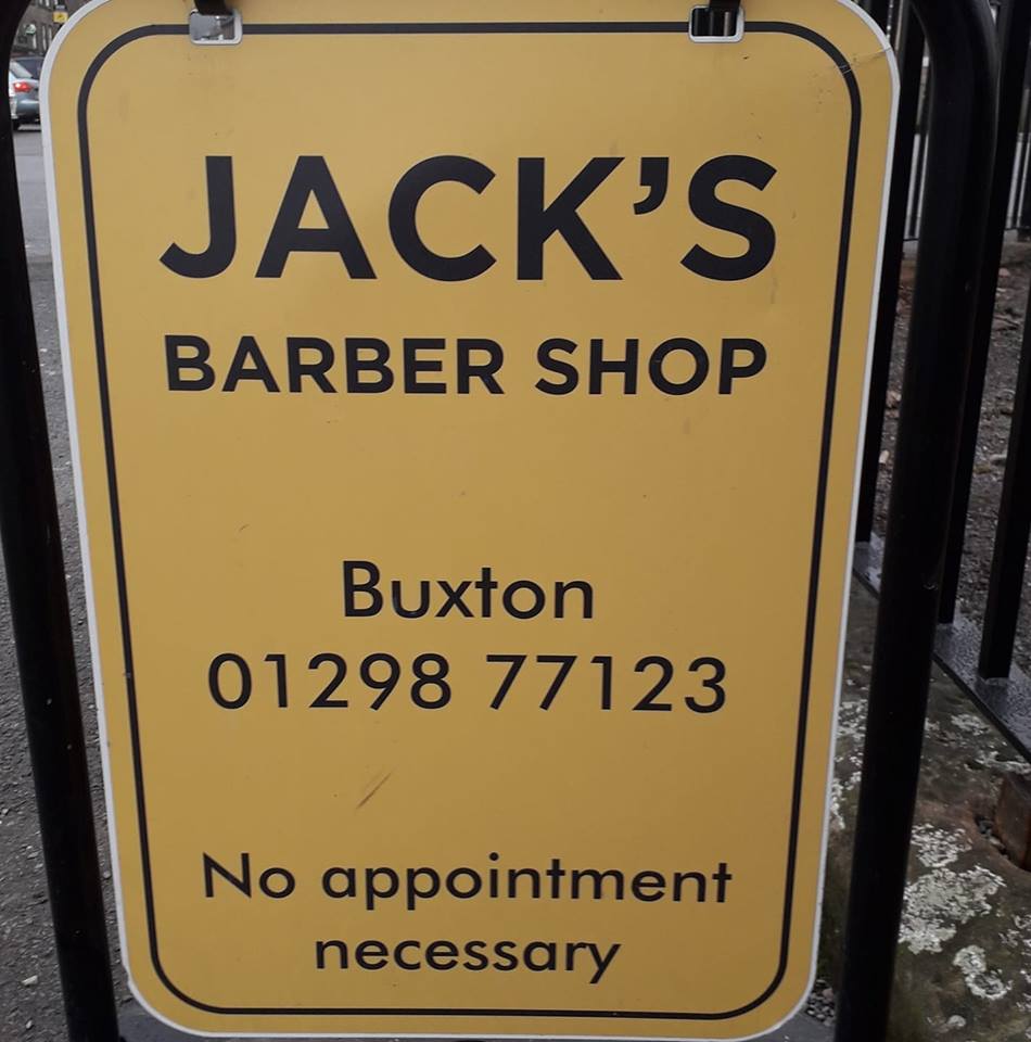 Image of hair being cut with a pair of scissors 